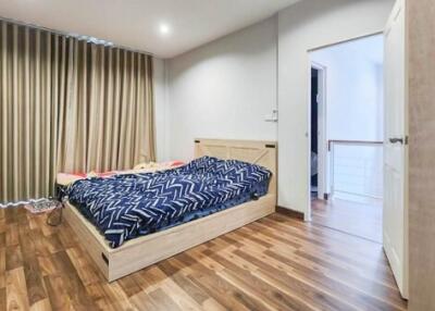 Modern furnished bedroom with wooden flooring