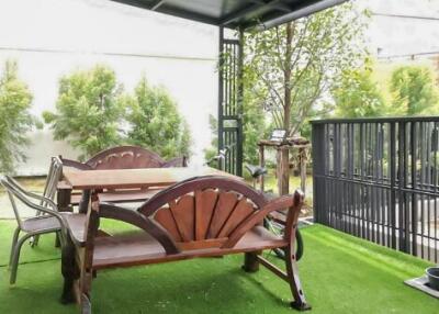 Outdoor patio with table, chairs and greenery