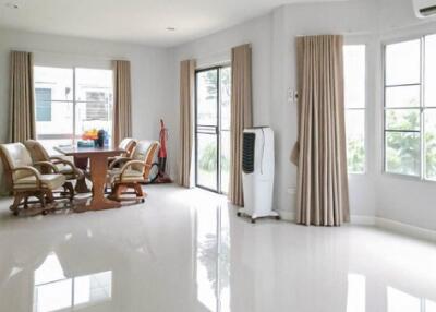 Bright main living area with large windows and modern furnishings