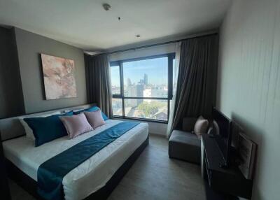 Modern bedroom with large window and city view