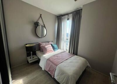 A cozy modern bedroom with a single bed near the window