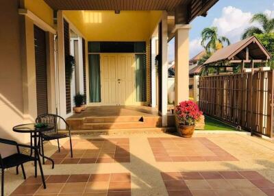 Front porch of a house with outdoor seating and plants