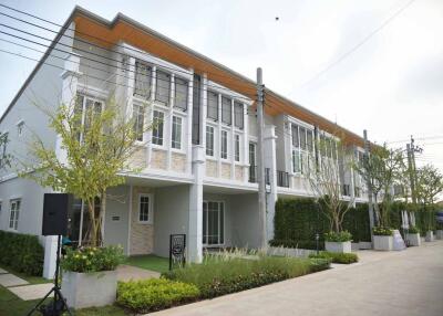 Modern townhouse exterior with manicured landscape