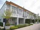 Modern townhouse exterior with manicured landscape