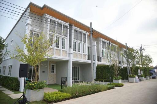 Modern townhouse exterior with manicured landscape