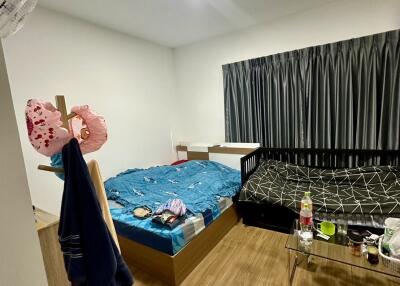 Bedroom with two beds and wooden flooring