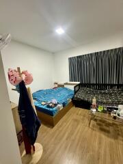 Bedroom with two beds and wooden flooring