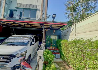 Exterior view of the house showcasing the driveway and front garden