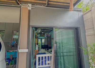 Entrance to a house with sliding glass door and bird nests hanging from the ceiling