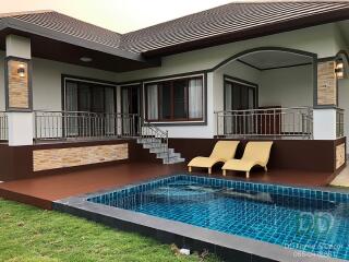 Backyard view with pool and seating area