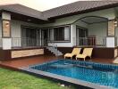 Backyard view with pool and seating area