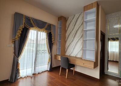 Bedroom with a modern desk and large window