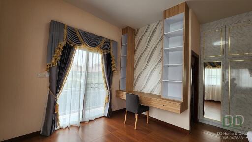 Bedroom with a modern desk and large window