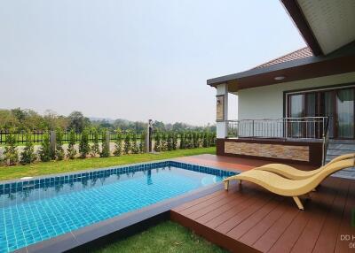 Outdoor pool and deck with loungers