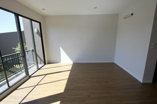 Spacious living room with large windows and balcony access