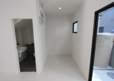 Minimalist bathroom and laundry area with modern fixtures