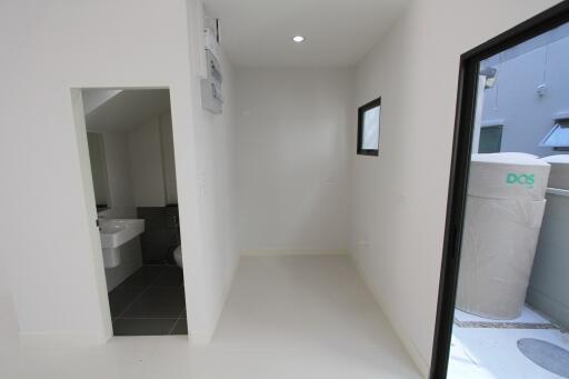 Minimalist bathroom and laundry area with modern fixtures