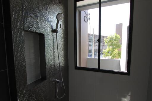 Bathroom with textured wall tiles and window