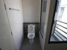 Bathroom with toilet and window