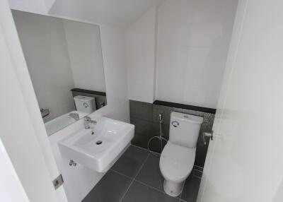 Modern bathroom with sink, mirror, and toilet