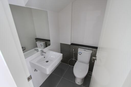 Modern bathroom with sink, mirror, and toilet