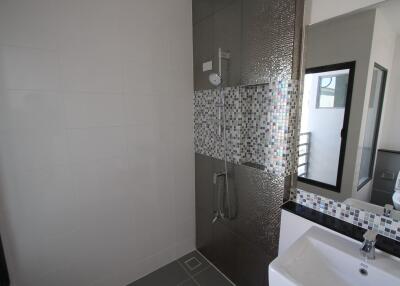 Modern bathroom with a walk-in shower and vanity area