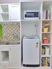 Compact kitchen space with integrated laundry area