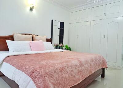 Spacious bedroom with large bed and built-in wardrobe