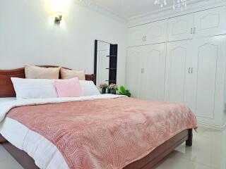 Spacious bedroom with large bed and built-in wardrobe