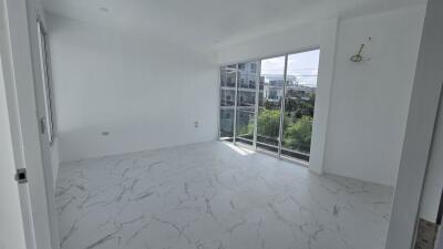 Bright and spacious bedroom with large window and balcony access