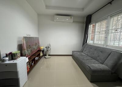 Living room with air conditioning, sofa and storage cabinet