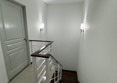 Modern staircase with white walls and wooden steps