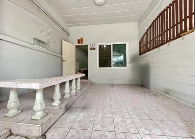 Covered porch with tiled floor and bench