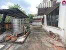 Outdoor area with garden shed, water tank, and planters