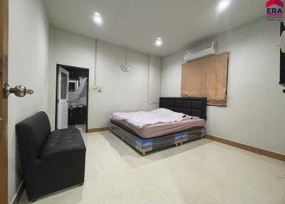 Spacious bedroom with bed, air conditioner, and sofa