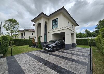 A two-story house with a driveway and garage