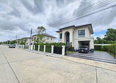 Modern two-story house with a driveway and car parked outside