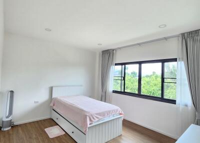 Spacious bedroom with large window