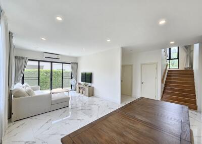 Spacious and modern living room with abundant natural light and sleek design.