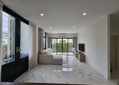 Modern living room with large windows and marble flooring