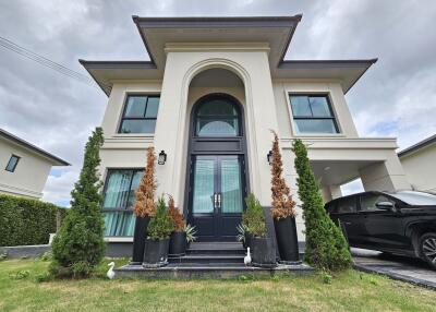 Two-story modern house with landscaped front yard