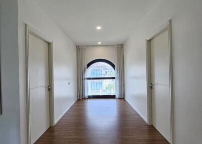 Spacious hallway with wooden flooring and natural light