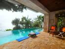 Tropical outdoor lounging space with infinity pool and ocean view