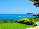 View of a seaside property with garden and pool