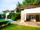 Exterior view of a modern house with pool and garden