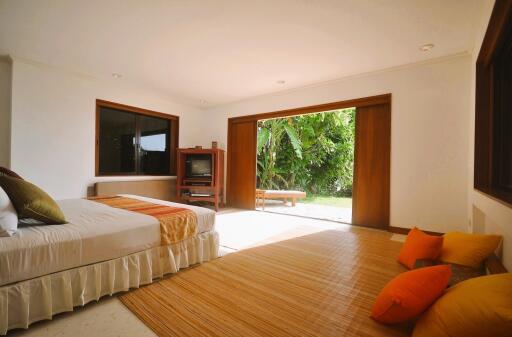 Spacious bedroom with large sliding door to garden