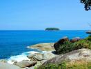 Seaside view with rocks and small island in the background