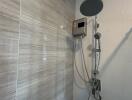 Modern shower with electric shower unit and handheld showerhead