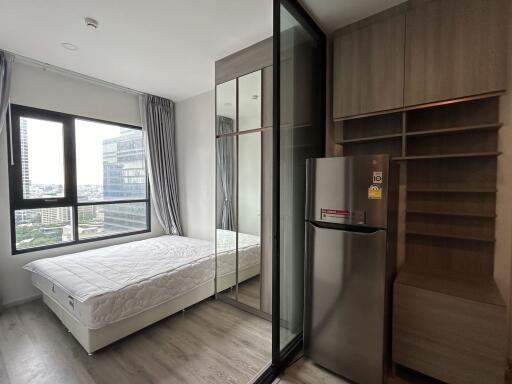 Modern bedroom with large windows and built-in storage