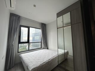 Modern bedroom with large window and city view